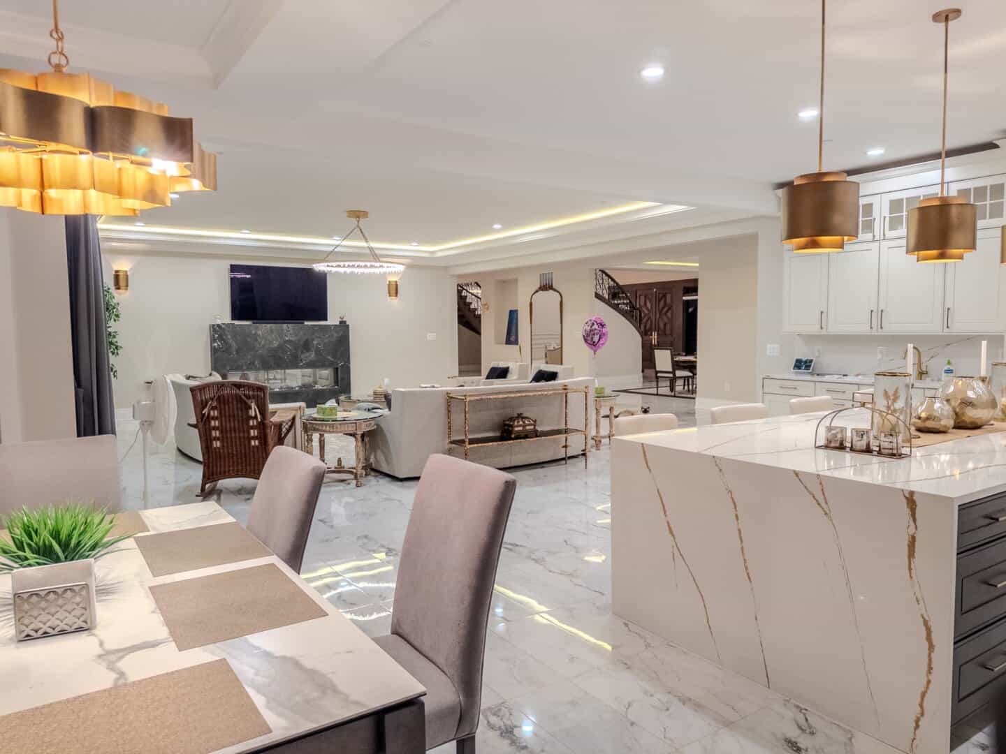 Photo of Noor Mahal's Great Room lounge, kitchen, and dining areas; shot taken at night with lights turned on.