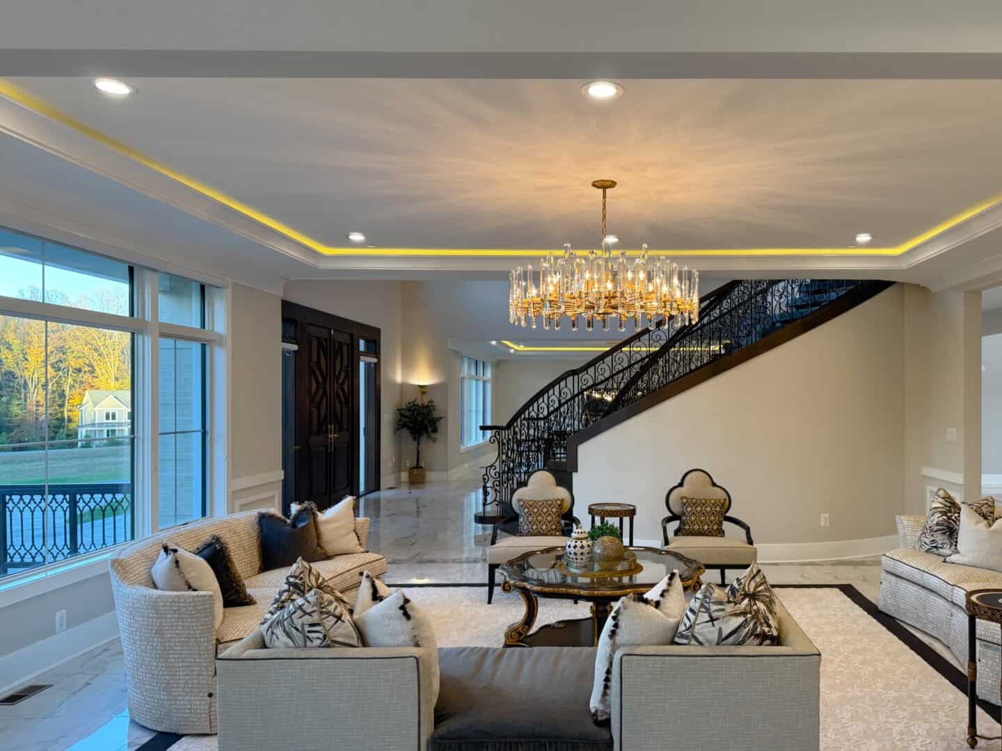 Photo of Noor Mahal's furnished parlor room with the foyer in the background; shot taken in daylight with interior lighting turned on.
